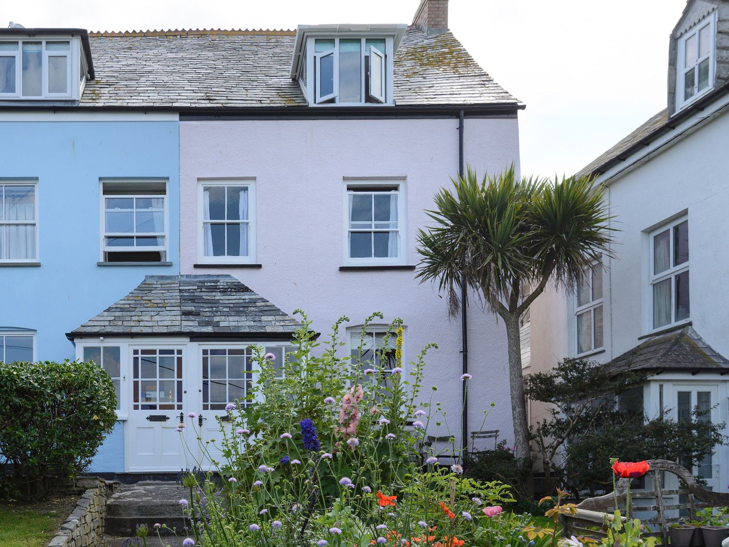 A house with a garden and flowers at 84 Fore Street Port Isaac