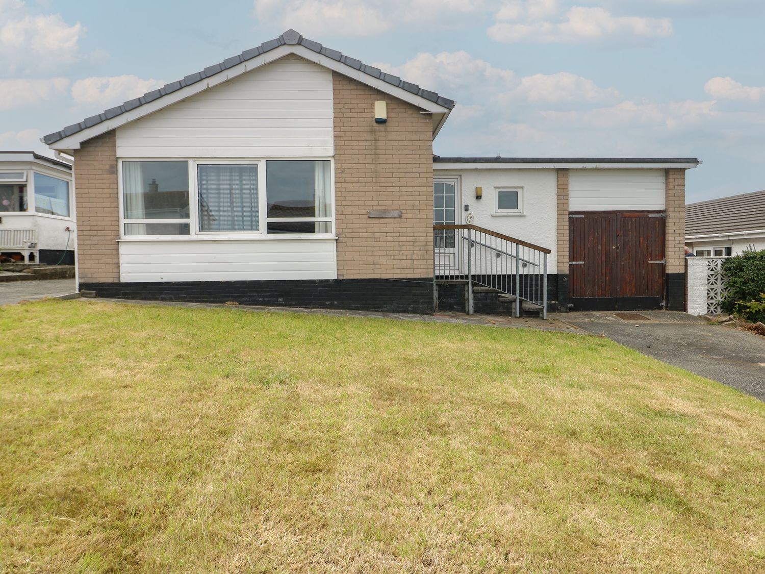 A house with a ramp and garage at 6 Gwelfor Estate