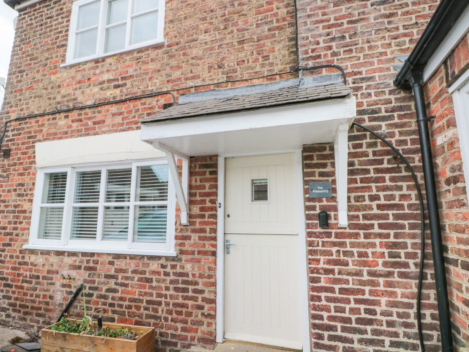 An entrance with a front door and a planter at The Pheasantry in Flamborough