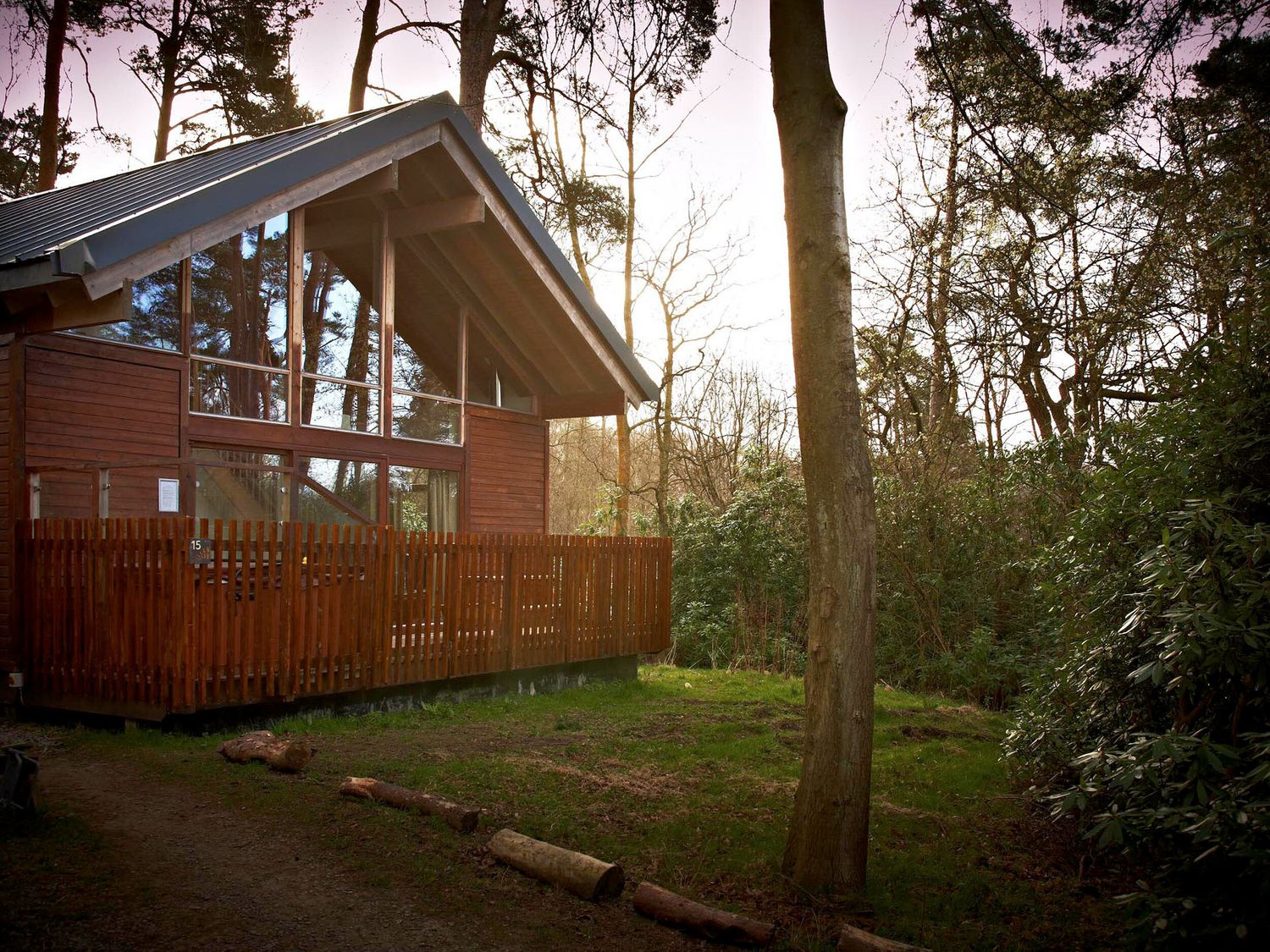 An outdoor area with a wooden cabin and deck at Strathyre Classic Silver Birch Strathyre, Ben Ledi
