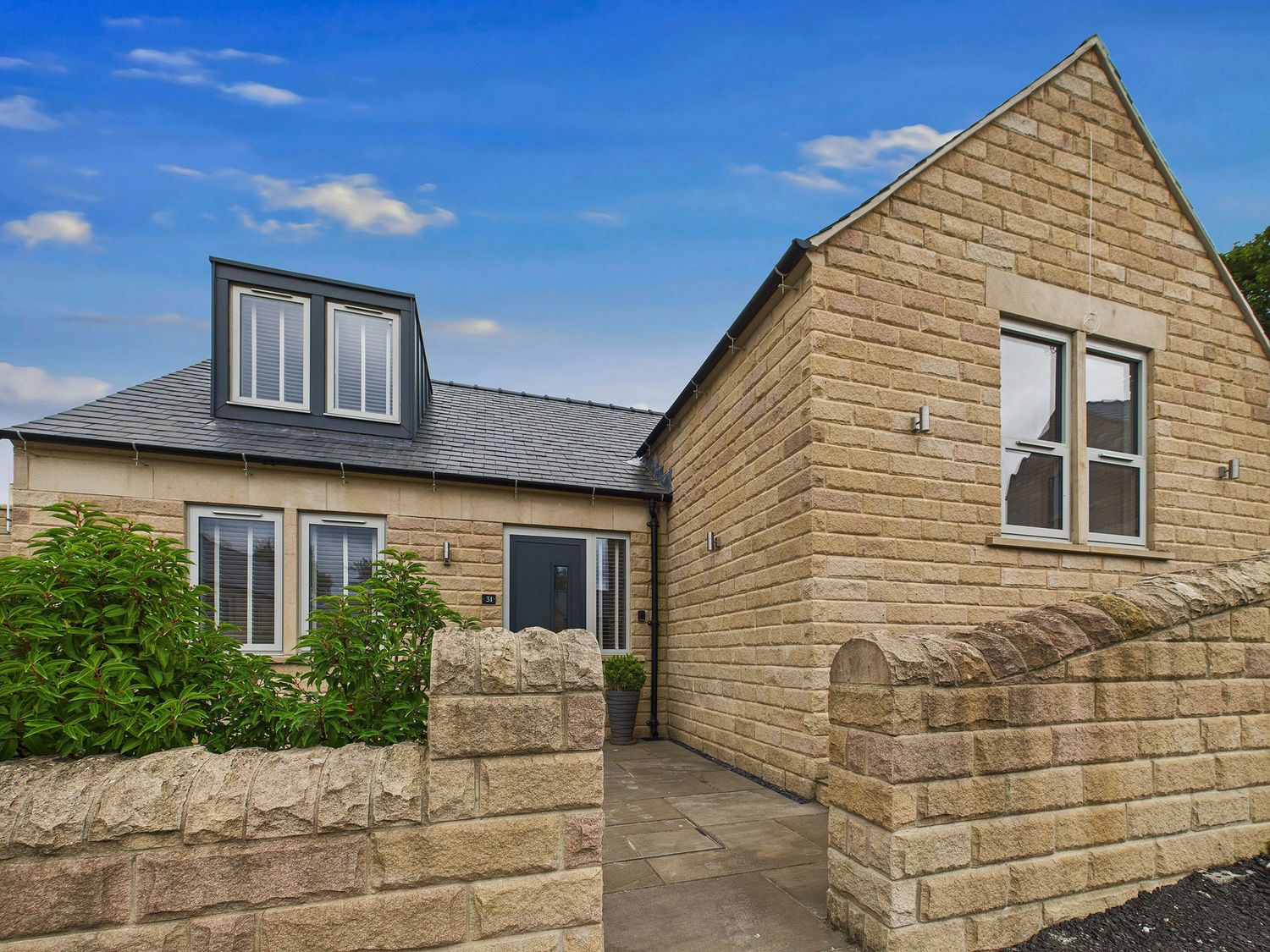 A house with a pathway and garden at Oakwood Lodge in Tansley