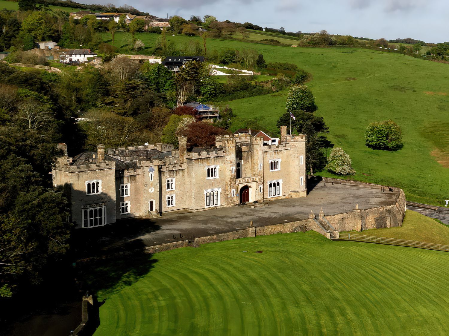 An image of a castle surrounded by green fields at Watermouth Castle, South Court Apartment in Berrynarbor near Ilfracombe