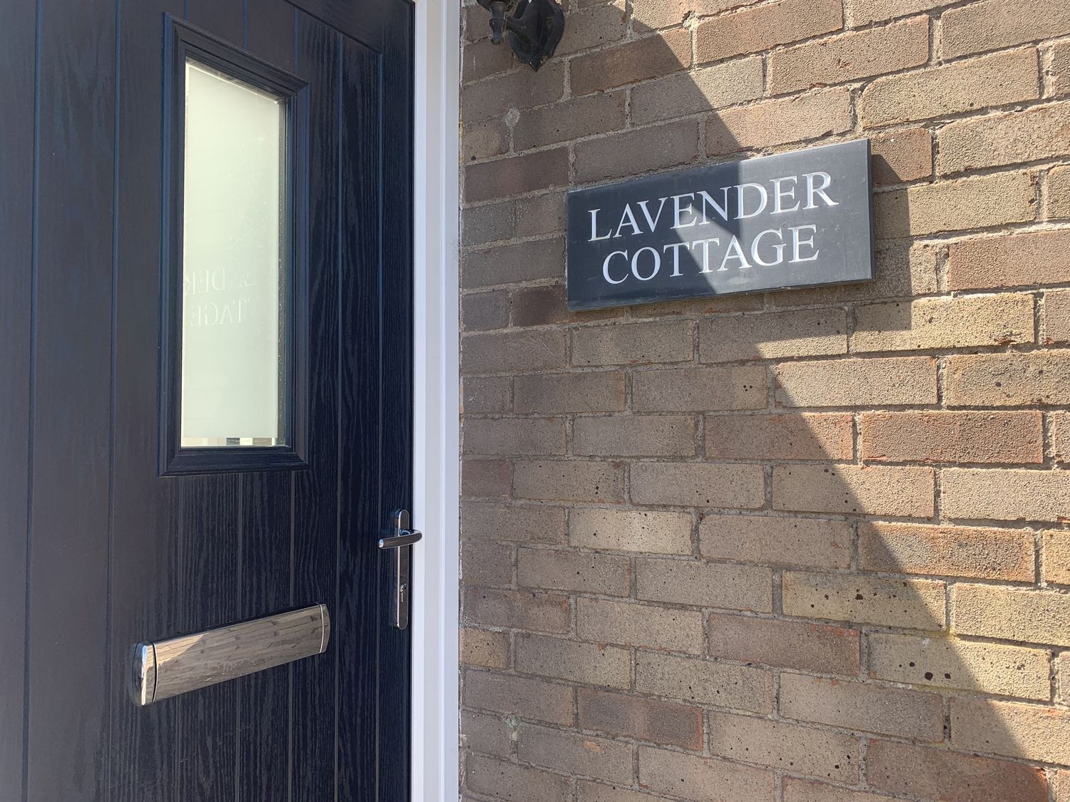 A door and nameplate at Lavender Cottage in Beadnell
