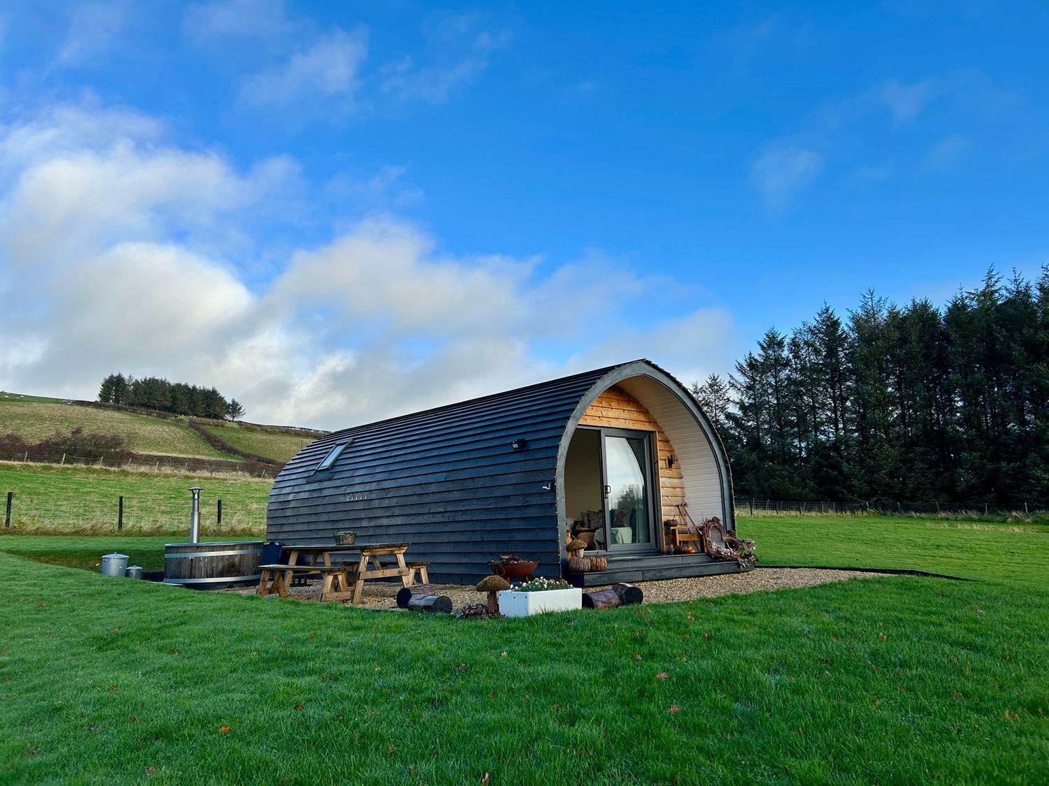 A cabin with hot tub and seating area at Willow in Llangurig near Llanidloes