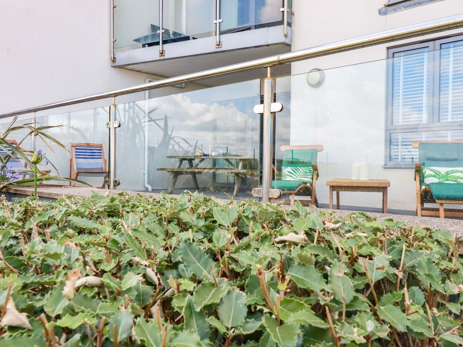 A balcony with chairs and a table at 4 Ocean Gate in Newquay