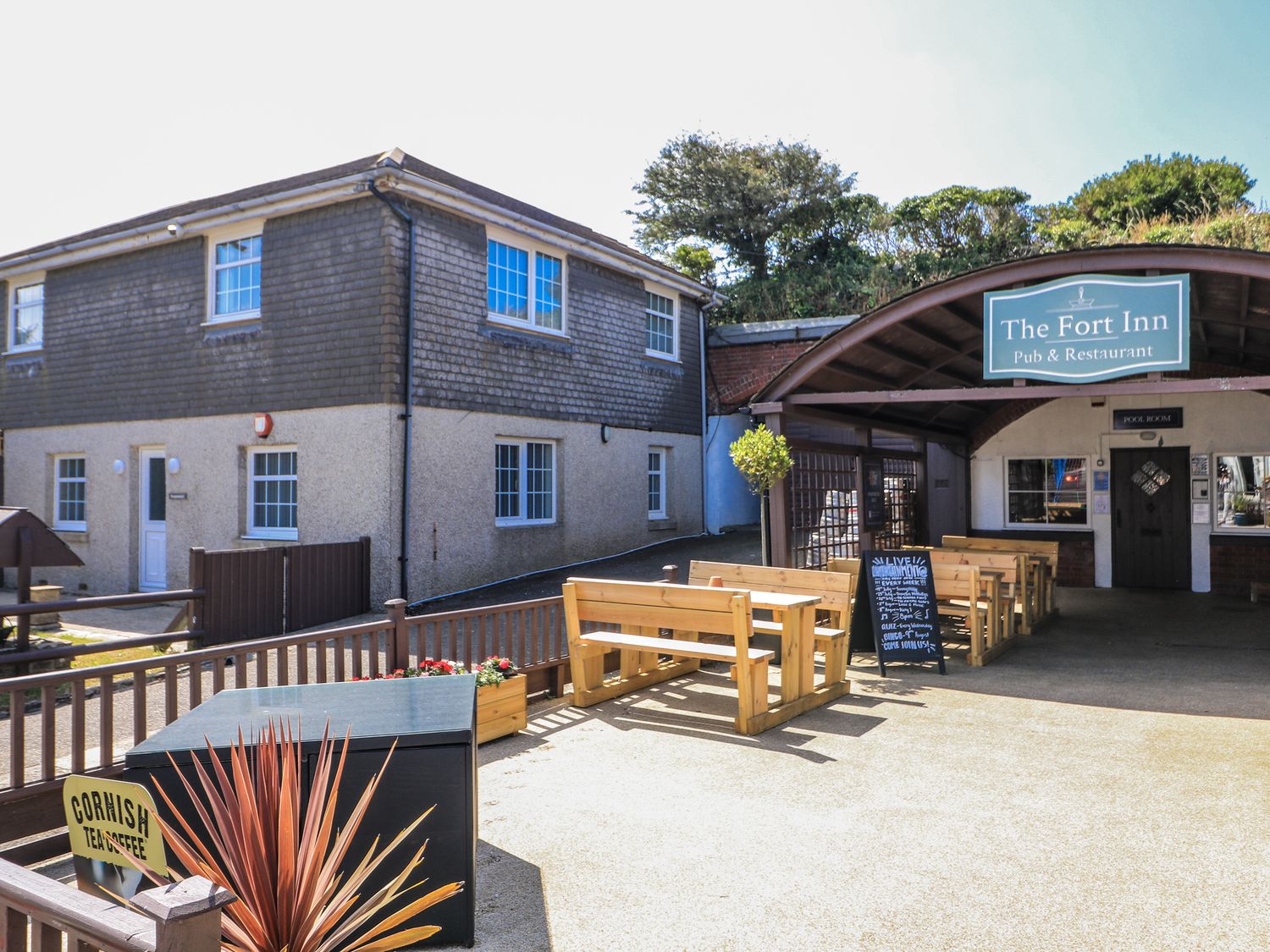 An outdoor seating area with benches at The Fort Inn in Torpoint