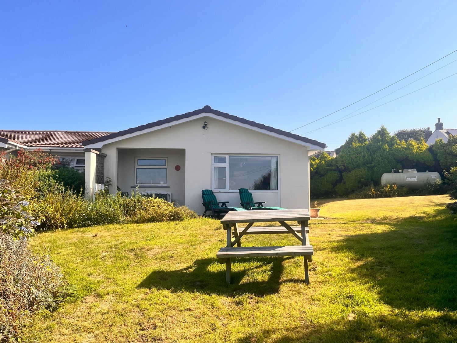 A house with a lawn and outdoor furniture at Merriview in Ashton Nr Helston