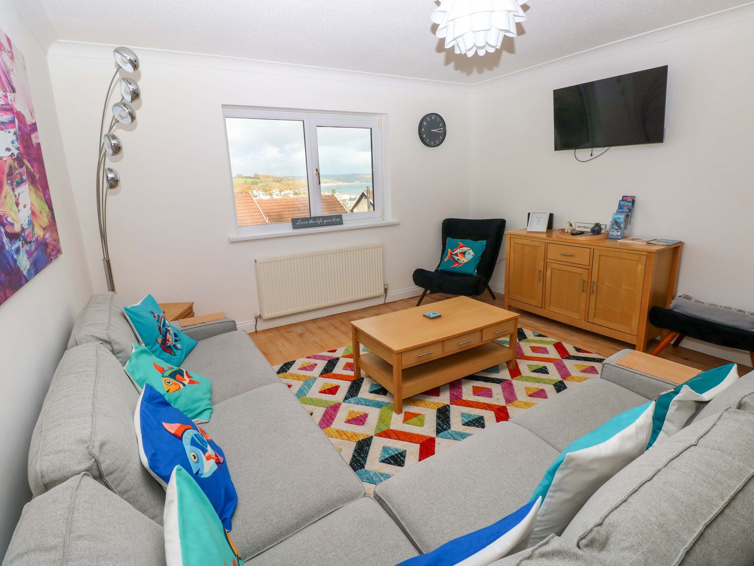 A living room with a sofa and coffee table at 15 Lawnswood Saundersfoot