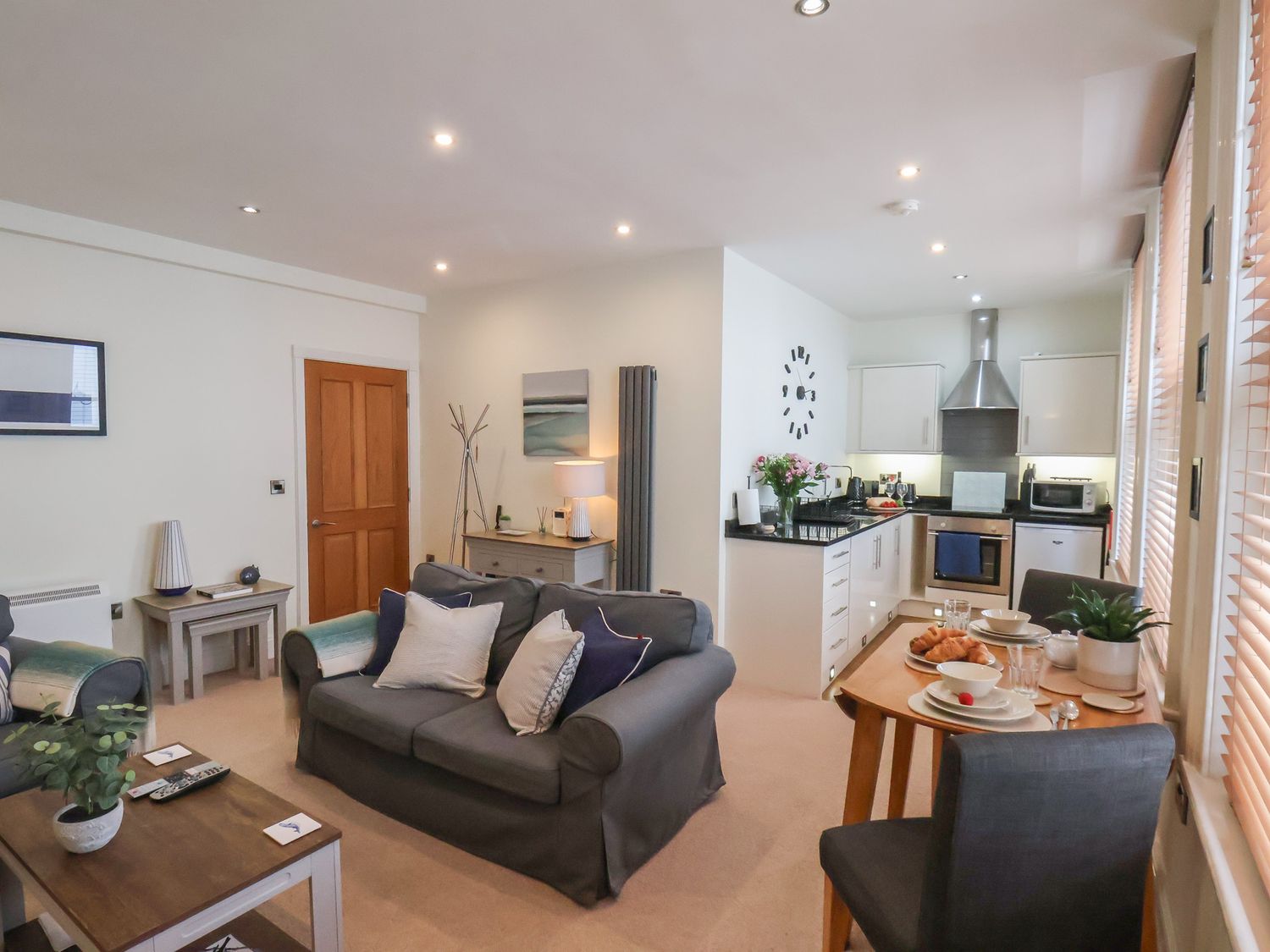A living room with a sofa and dining table at Jolly Roger in Whitby