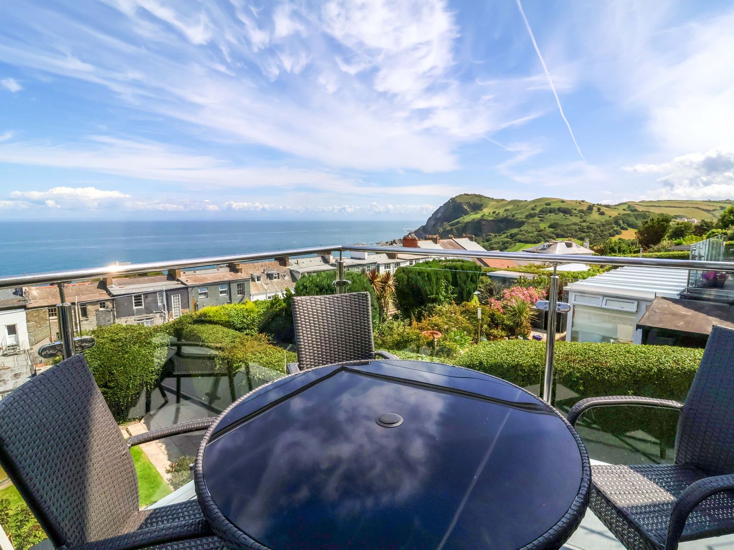 An outdoor seating area overlooking the sea at Combe View in Ilfracombe
