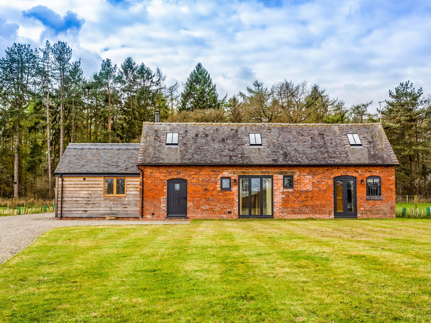 A house with brick and wooden exterior at Johnsons Smallholding Market Drayton