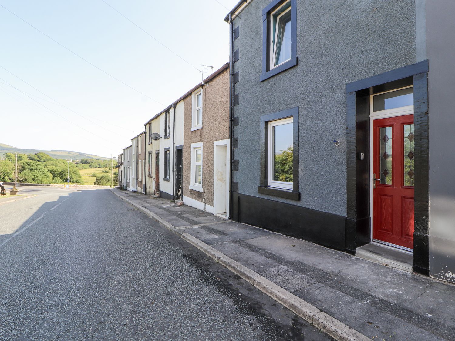 A street with houses and a red door at 10 Keekle Terrace in Cleator Moor