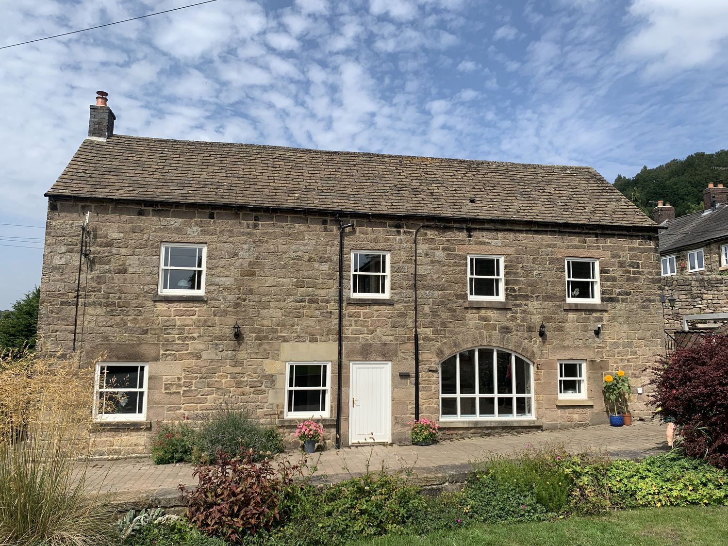A stone house with windows and a front door at The Coach House in Holloway