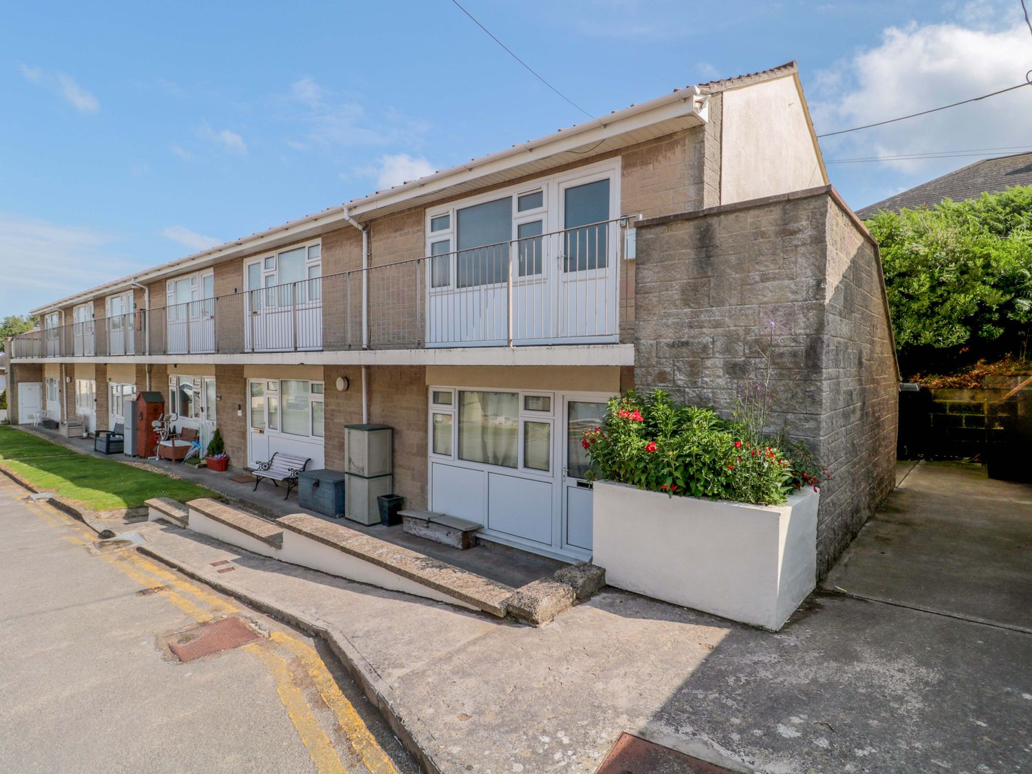 A building with balconies and planters at Flat 24 Brean
