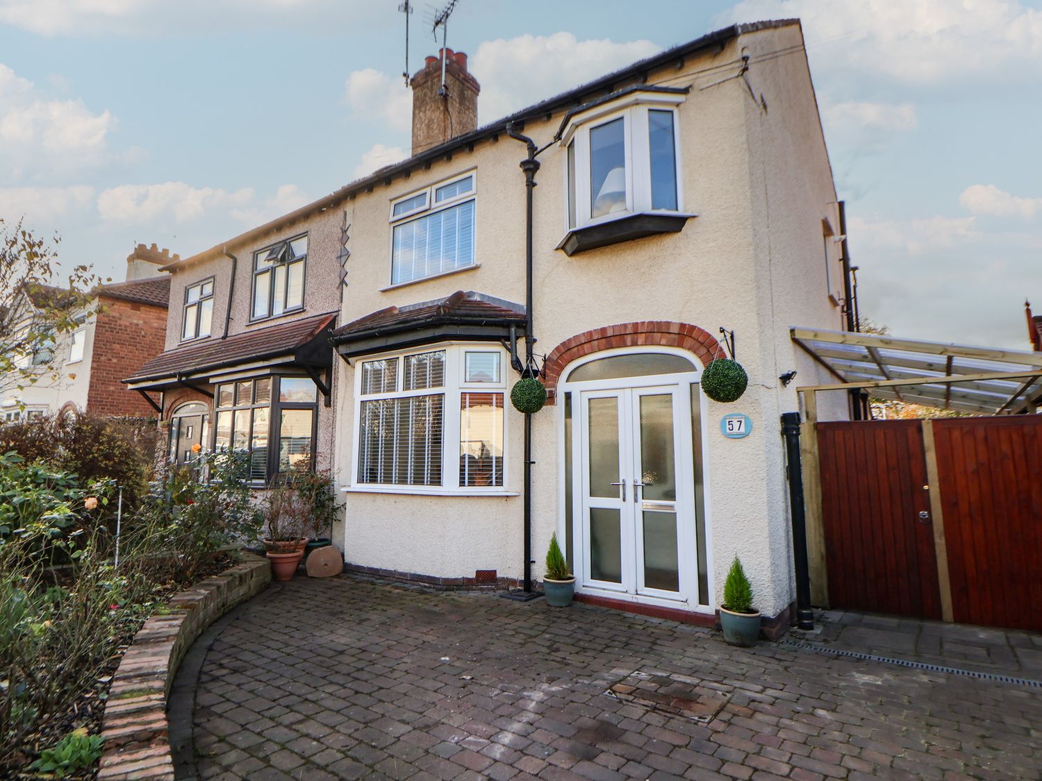 A house with a driveway and plants at 57 Broadway West Chester