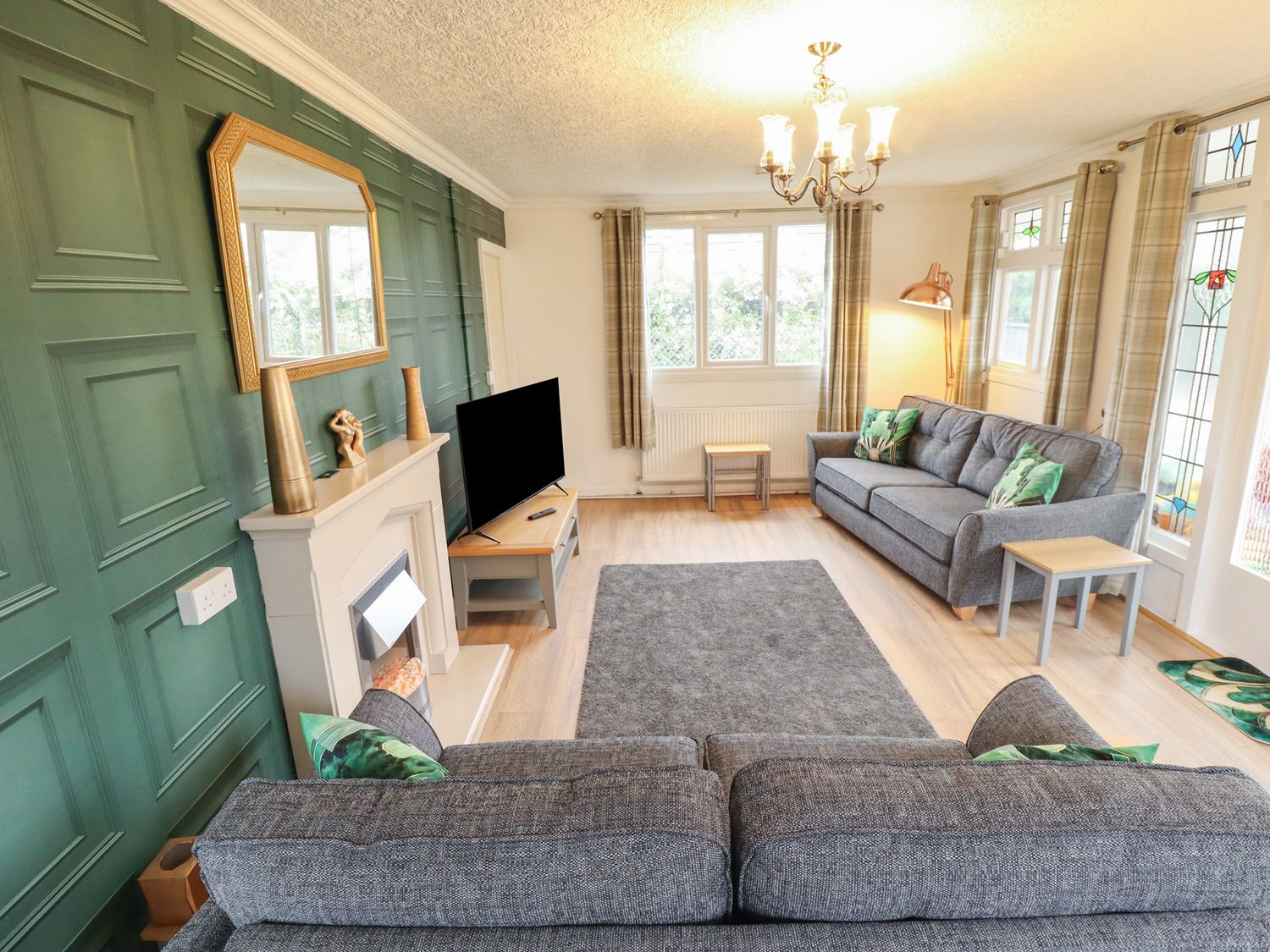 A living room with a sofa and coffee table at Orby Cottage in Chapel St Leonards