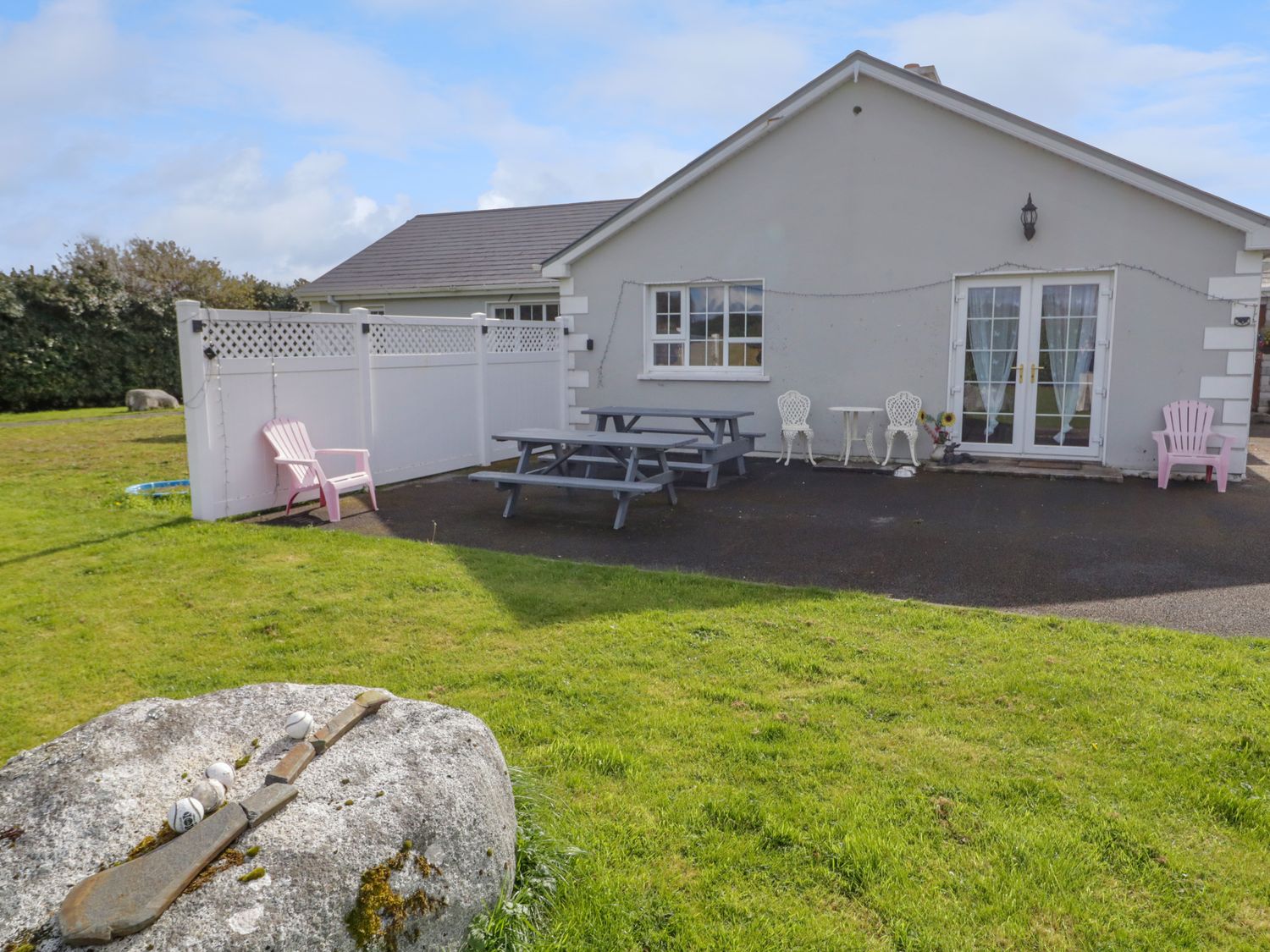 A patio with picnic tables and chairs outside a house at Thomond Hill in Narin County Donegal