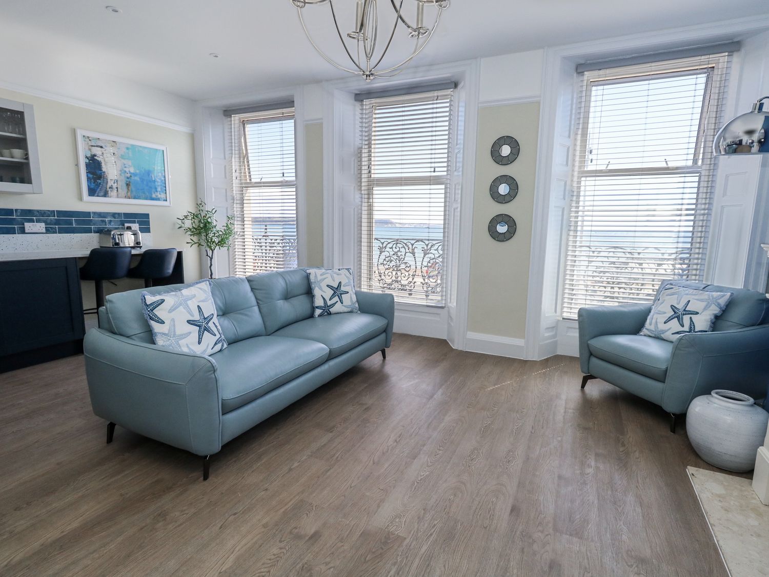 A living room with a sofa and armchair at Apartment 1 in Weymouth