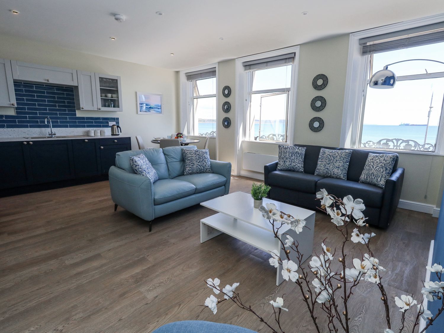 A living room with a coffee table and sofas at Apartment 2 in Weymouth