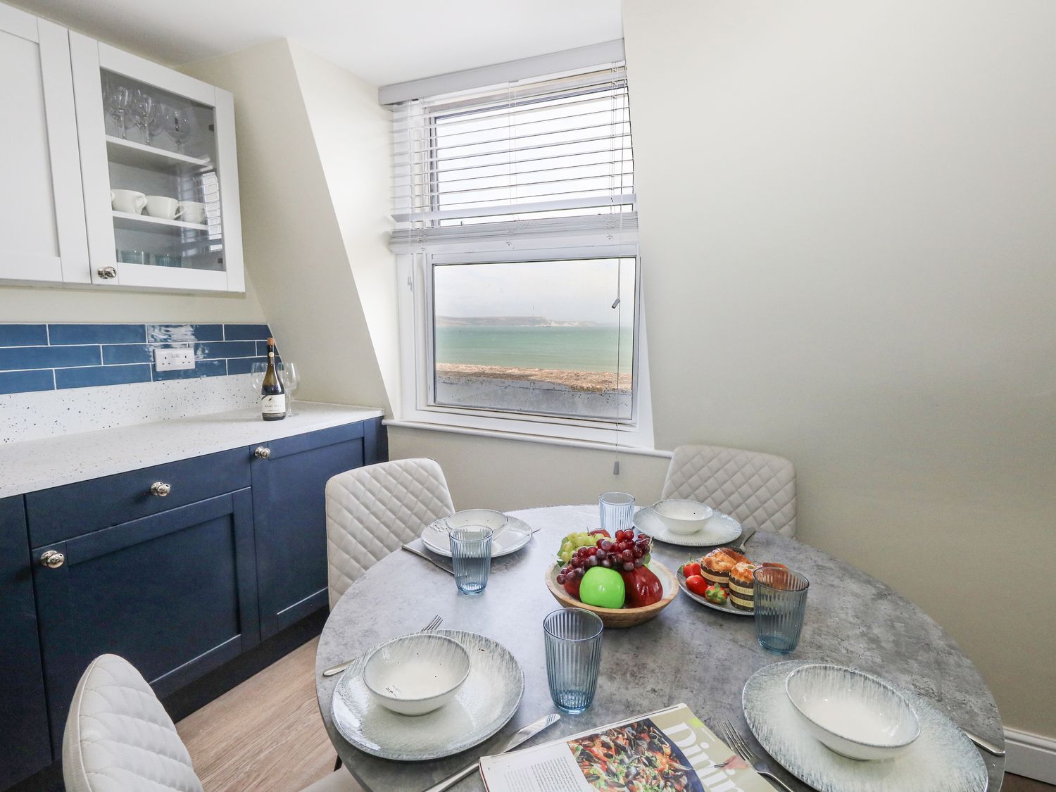 A kitchen with a dining table and chairs at Apartment 3 in Weymouth