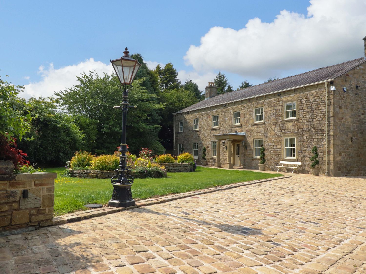 A house with a garden and lamp post at Laithe House in Burnley