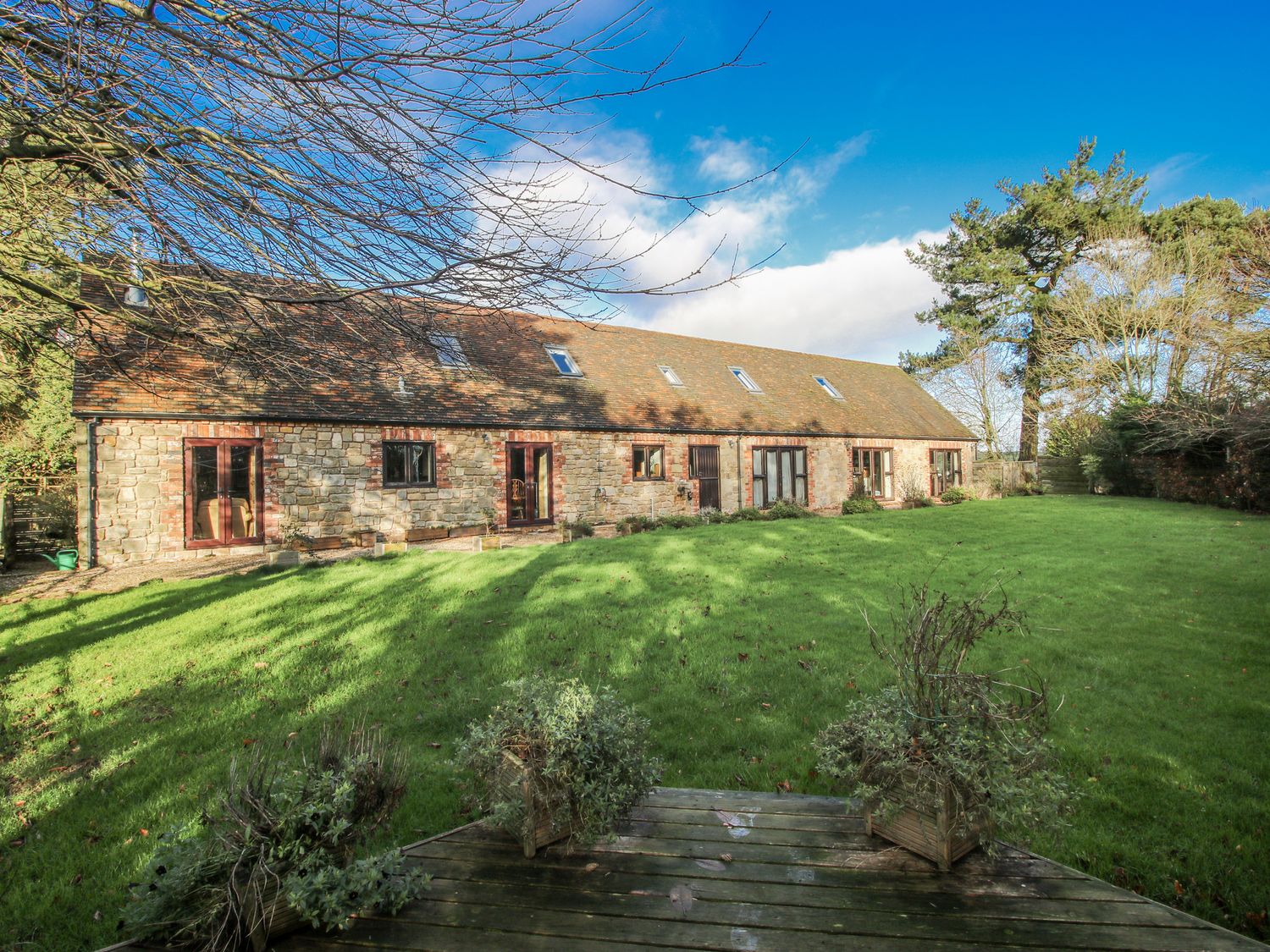 A house with windows and a lawn at Upper Home Farm near Cardington