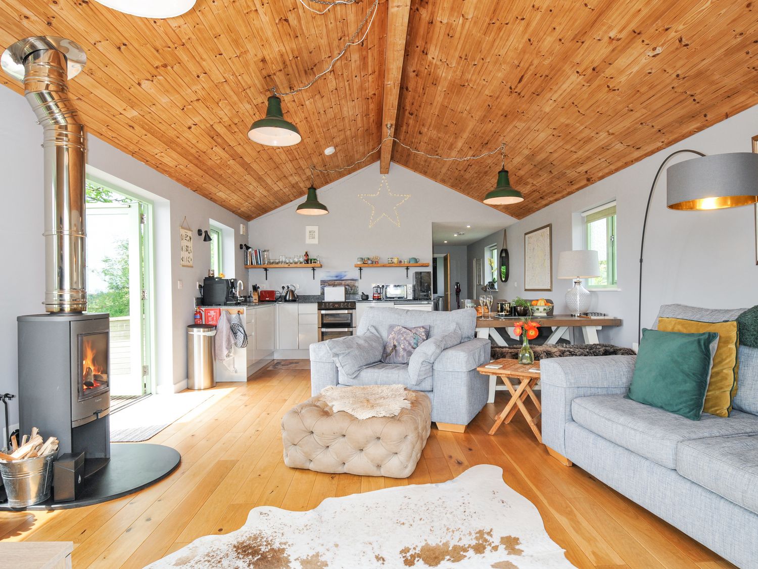 A living room with a sofa and a fireplace at Smugglers Bodmin Moor, St Breward near St Tudy