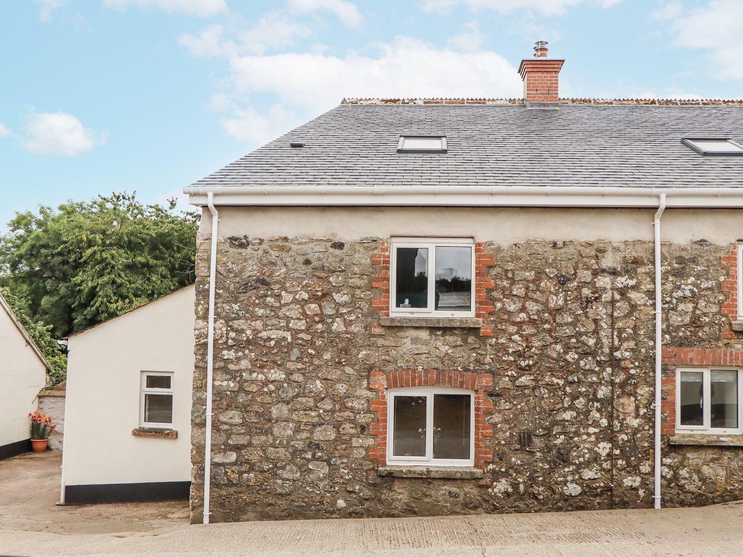 A stone building with windows at Aunty Junes Cottage in Okehampton