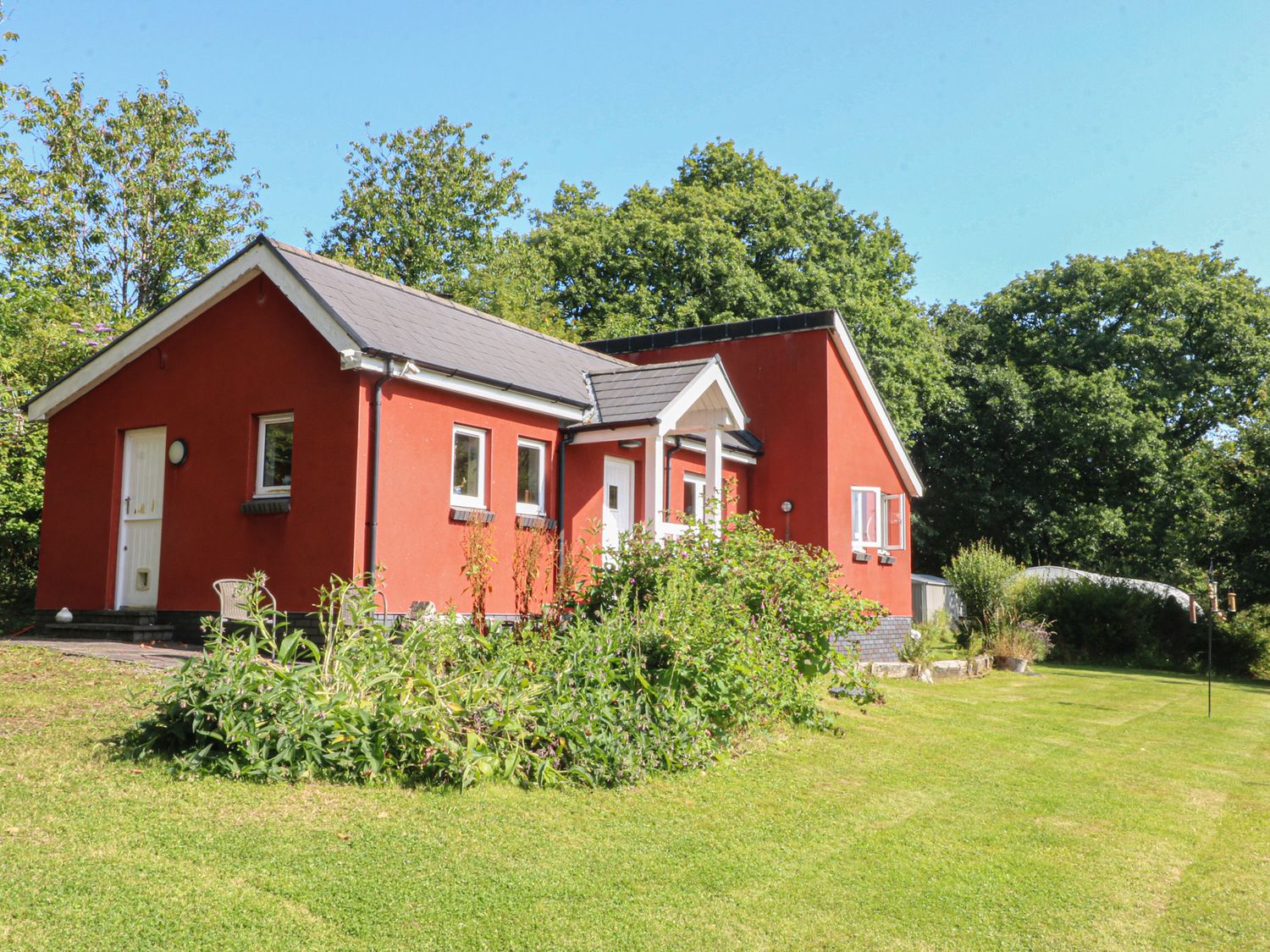 A house with a garden and trees at Delfryn Llandeilo near Llandeilo