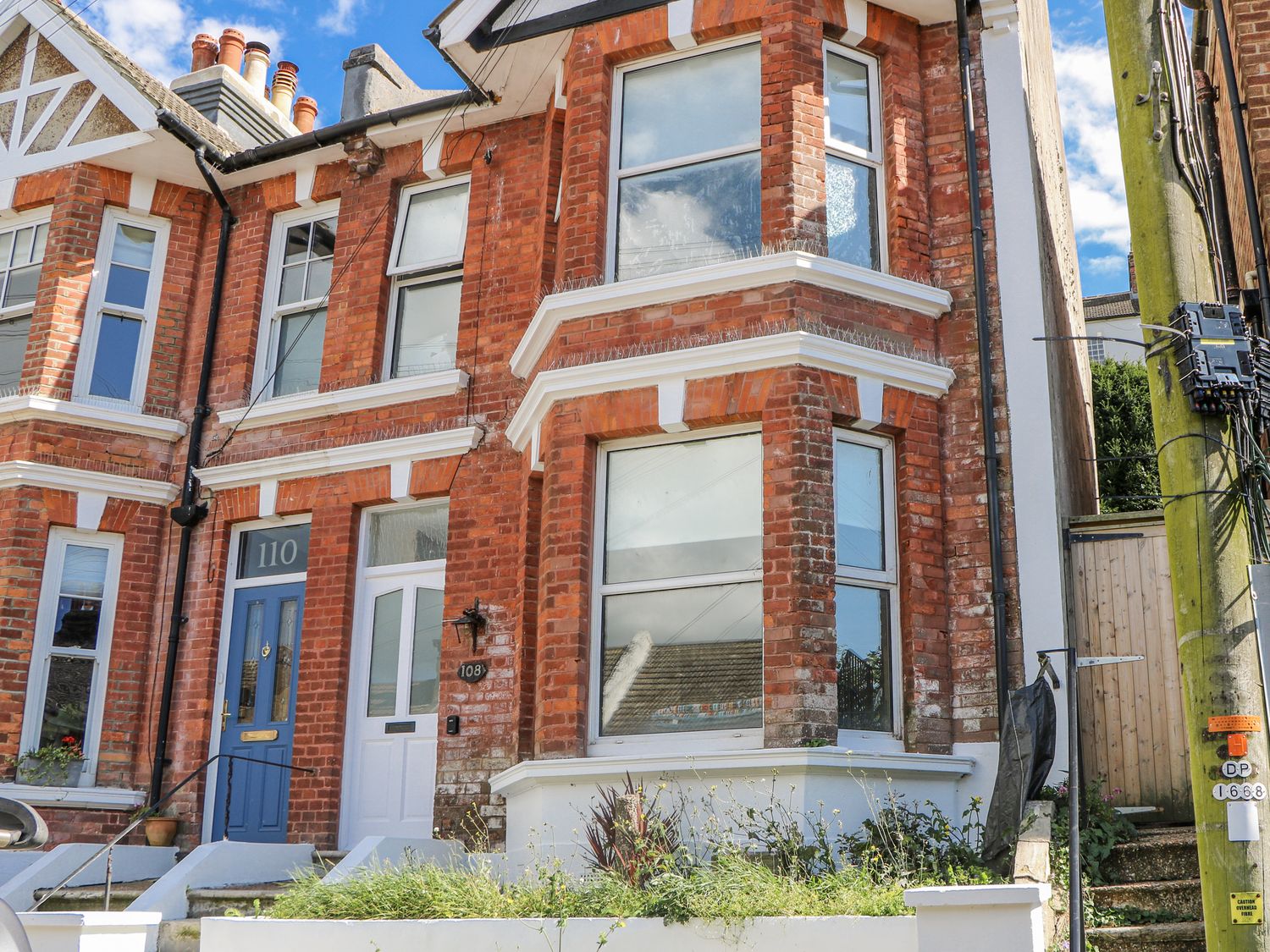 A brick exterior of a house with windows and a door at 108 Emmanuel Road Hastings