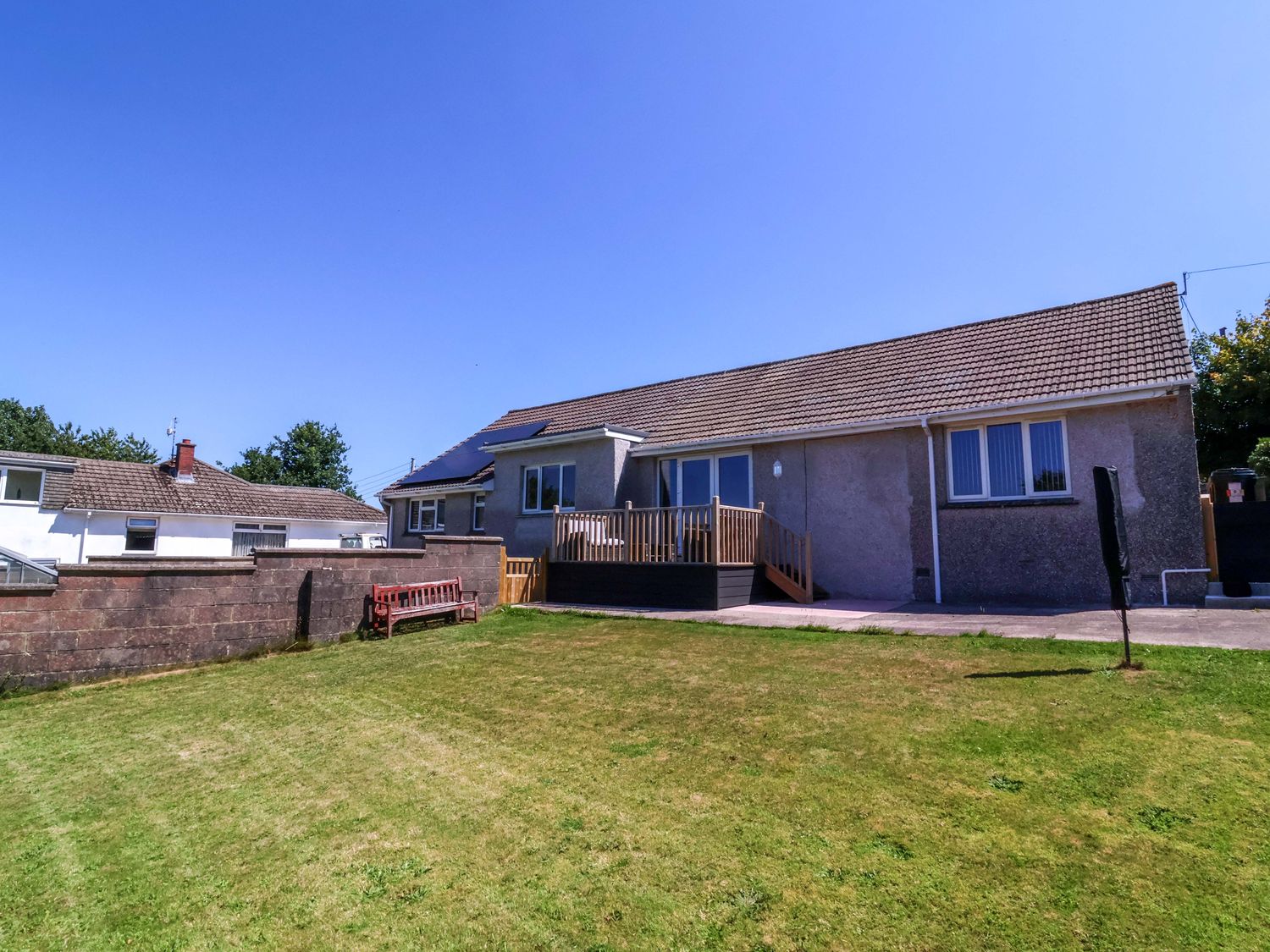 A house with a deck and lawn at West View Northlew near Hatherleigh