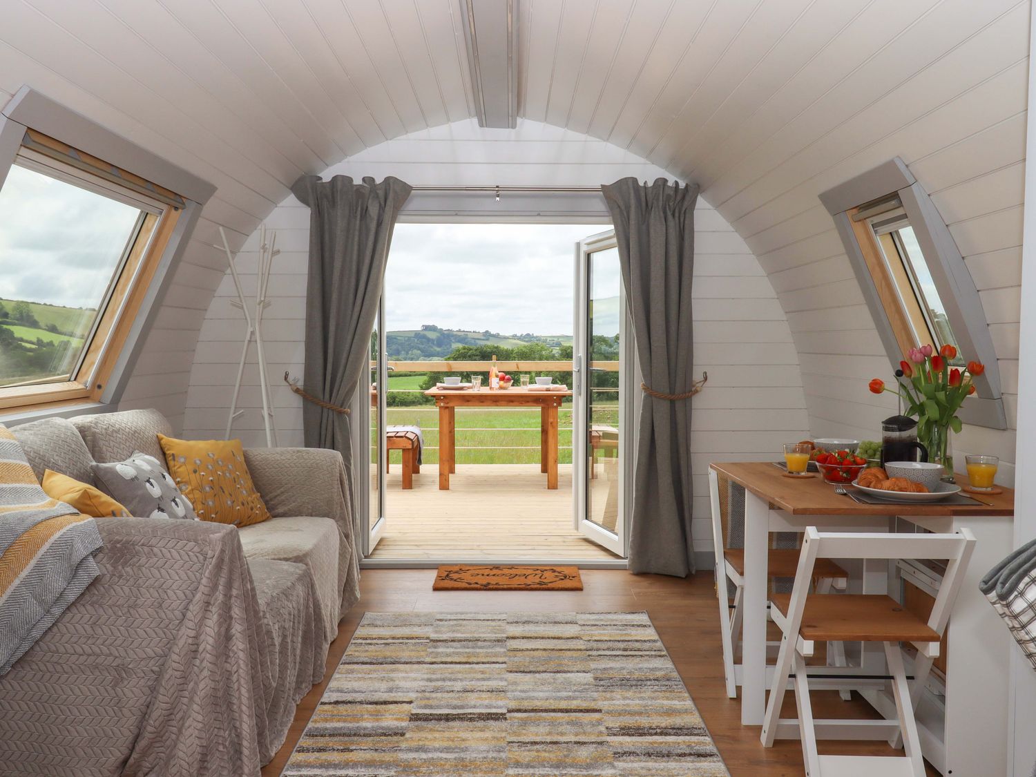 A living room with a sofa and table at Under Oak Pod in Totnes