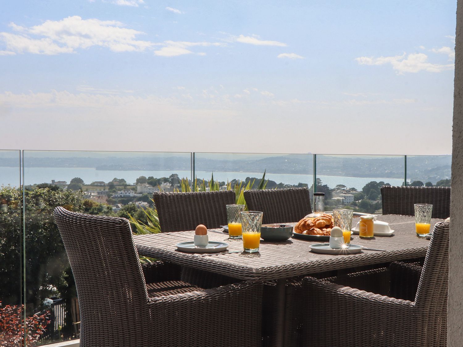 An outdoor dining area with a table set for breakfast at Seacroft in Torquay