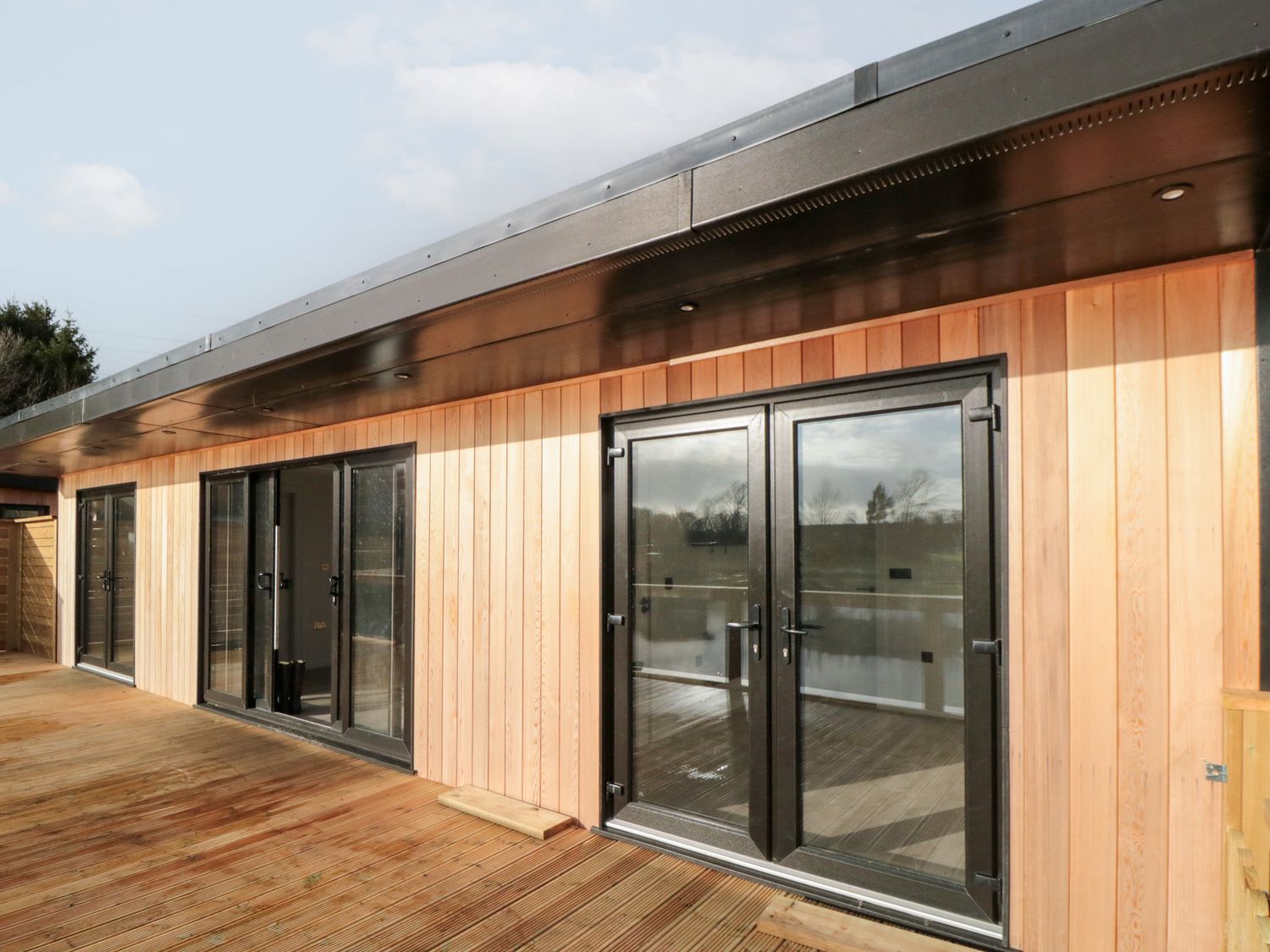 An outdoor area with wooden walls and sliding doors at Lodge 3 Stockton-on-Tees