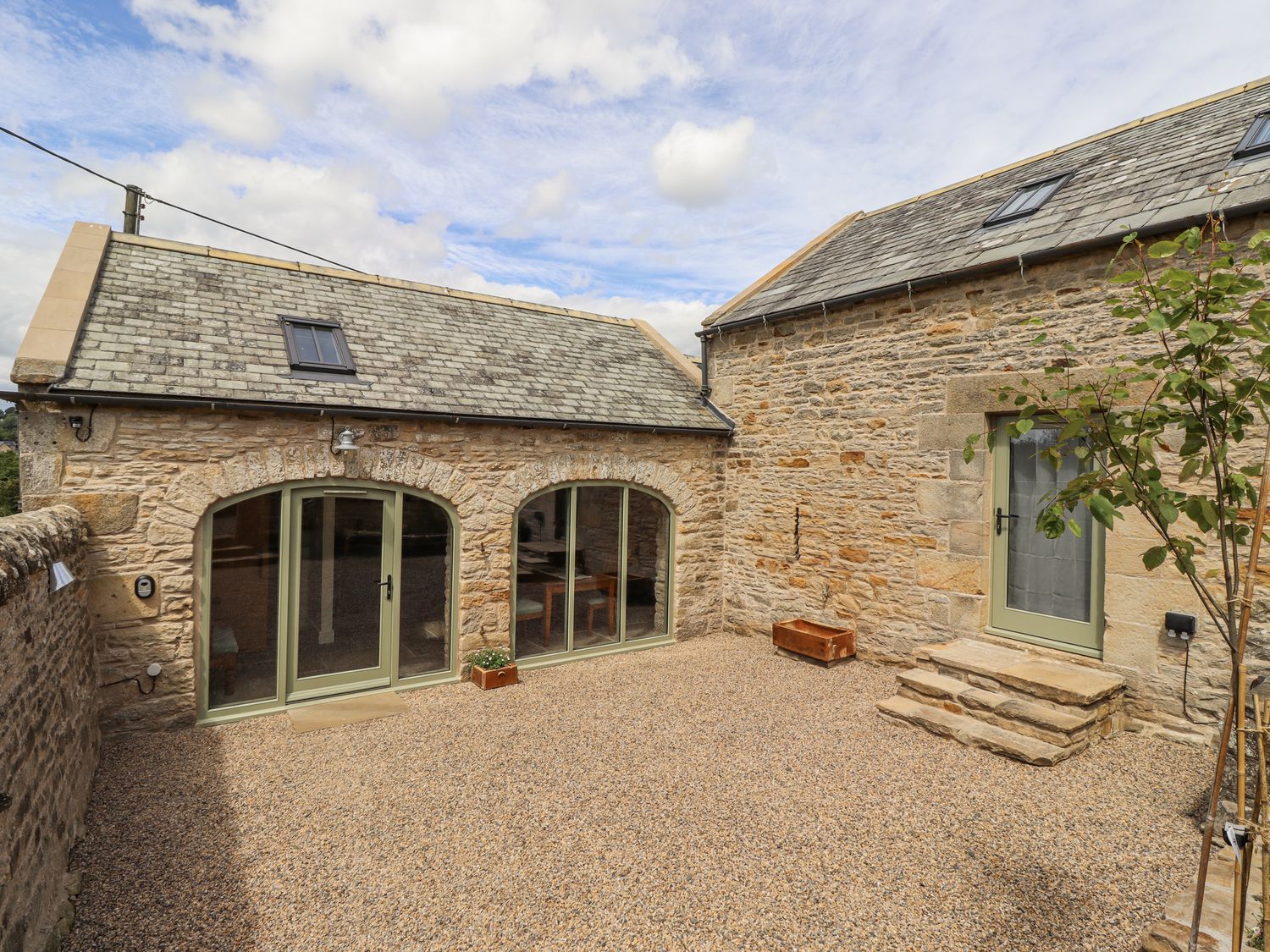 An outdoor area with stone building and gravel ground at West Dunkirk Hemmels Hexham