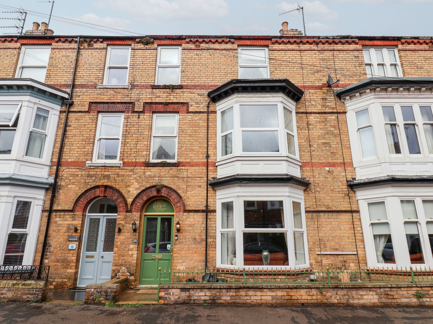 A brick facade with front doors and windows at Rutland Grange in Filey