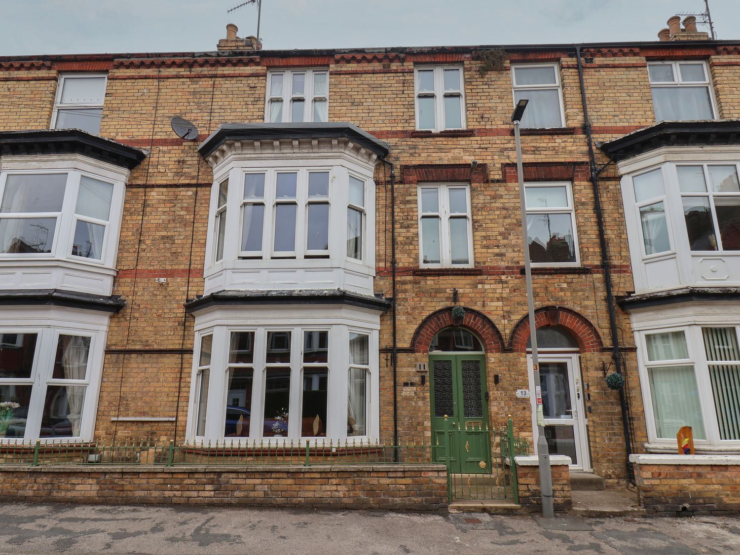 A front view of a multi-story brick building at 11 Rutland Street Filey