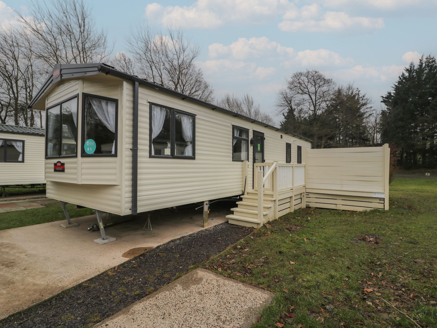A static caravan with steps and decking at Woodlands Gold (WO 41) in Ruthin