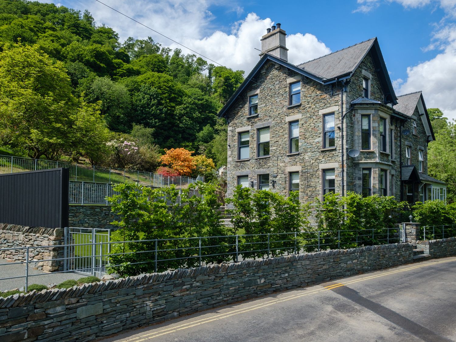A stone building surrounded by greenery at Riverside in Ambleside