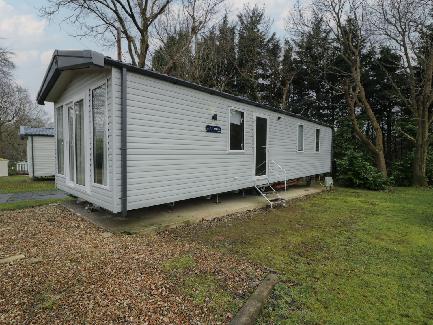 A cabin with windows and steps at Woodlands Gold (WO06) Ruthin