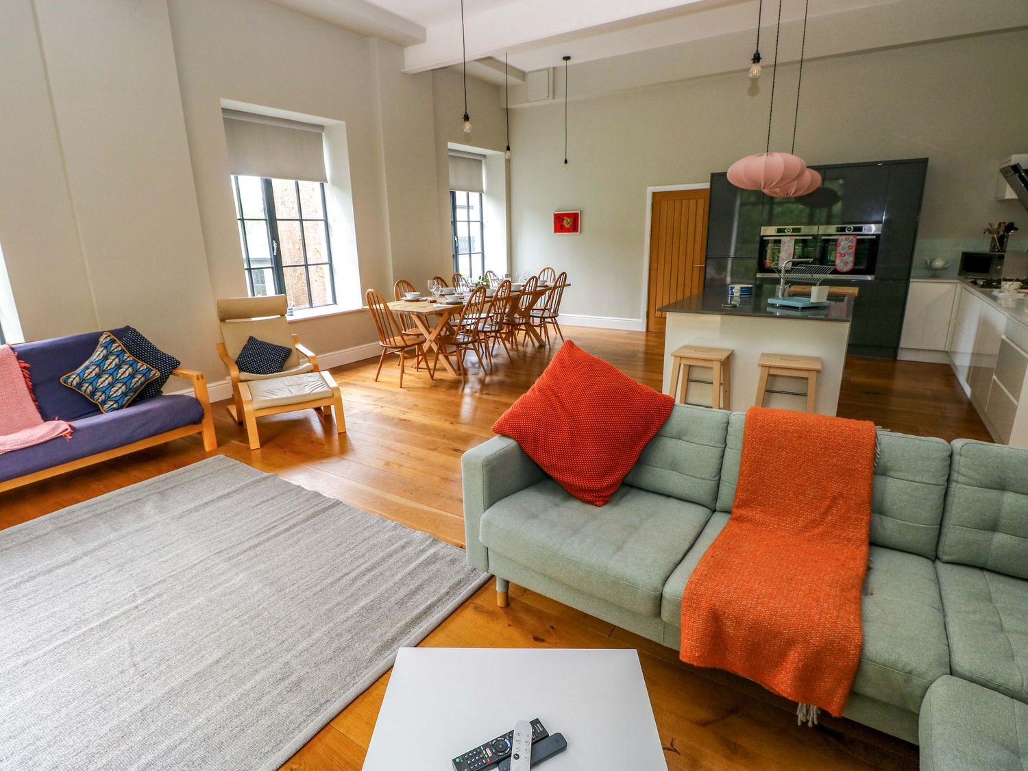 A living room with a sofa and dining area at The Old Creamery in Ffairfach