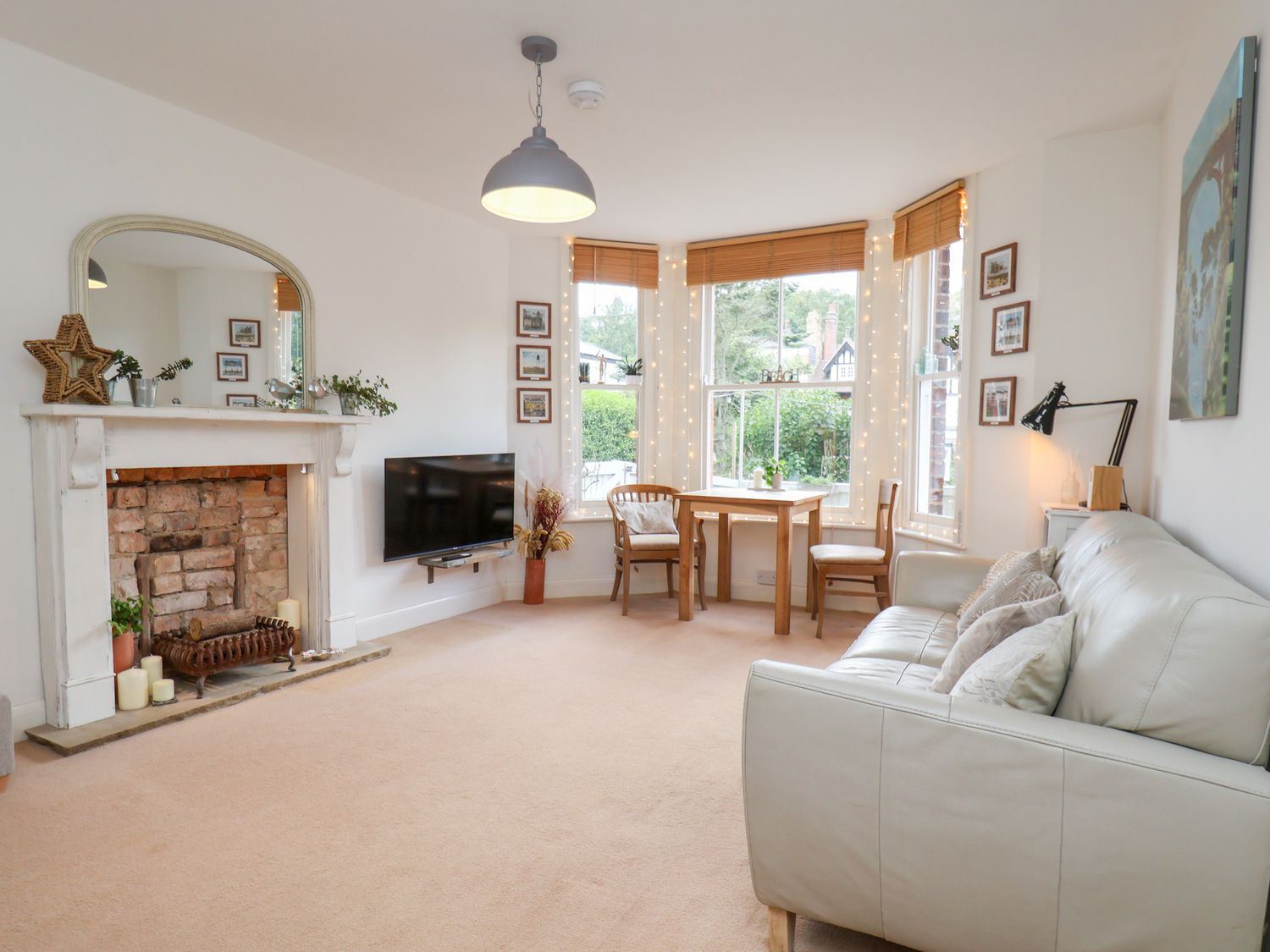 A living room with a fireplace and television at Happy Days in Scarborough