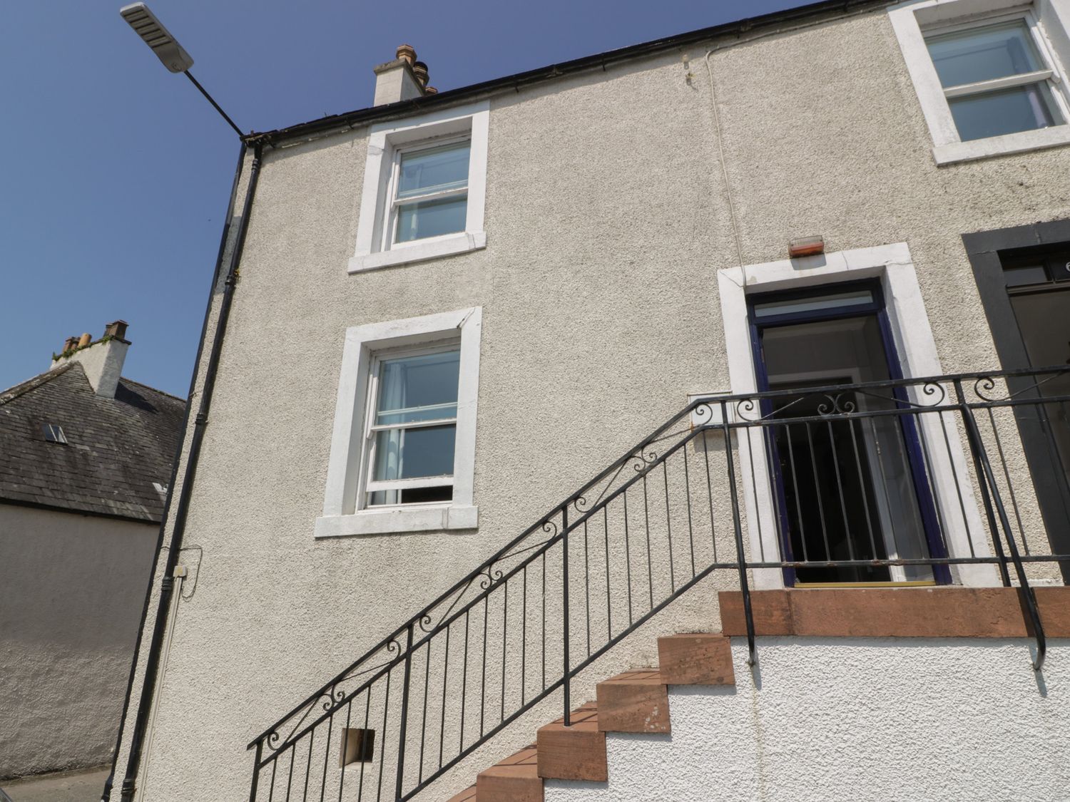 Exterior view of a building with windows and stairs at Fleet Townhouse in Castle Douglas