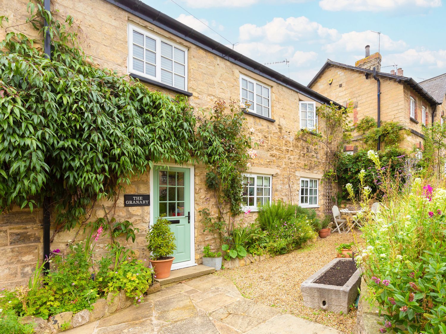 An outdoor view of The Granary in Aberford with a garden and seating area