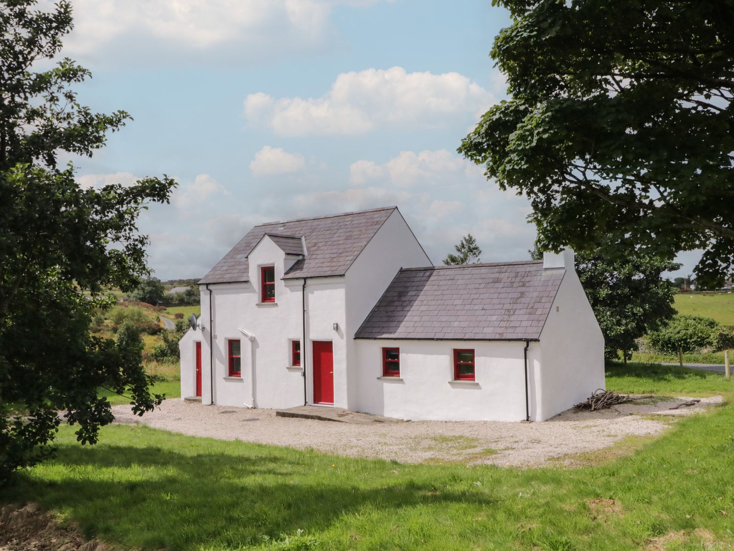 A house with red accents and a gravel area at Shane's Cottage, Falcarragh, County Donegal