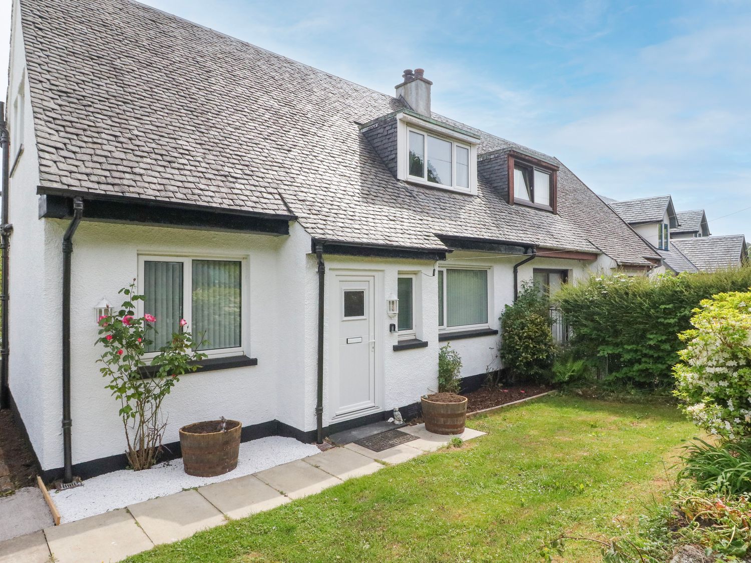 A house with a front garden and pathway at 3 Whin Bank, Clachan-Seil near Balvicar, Isle Of Seil