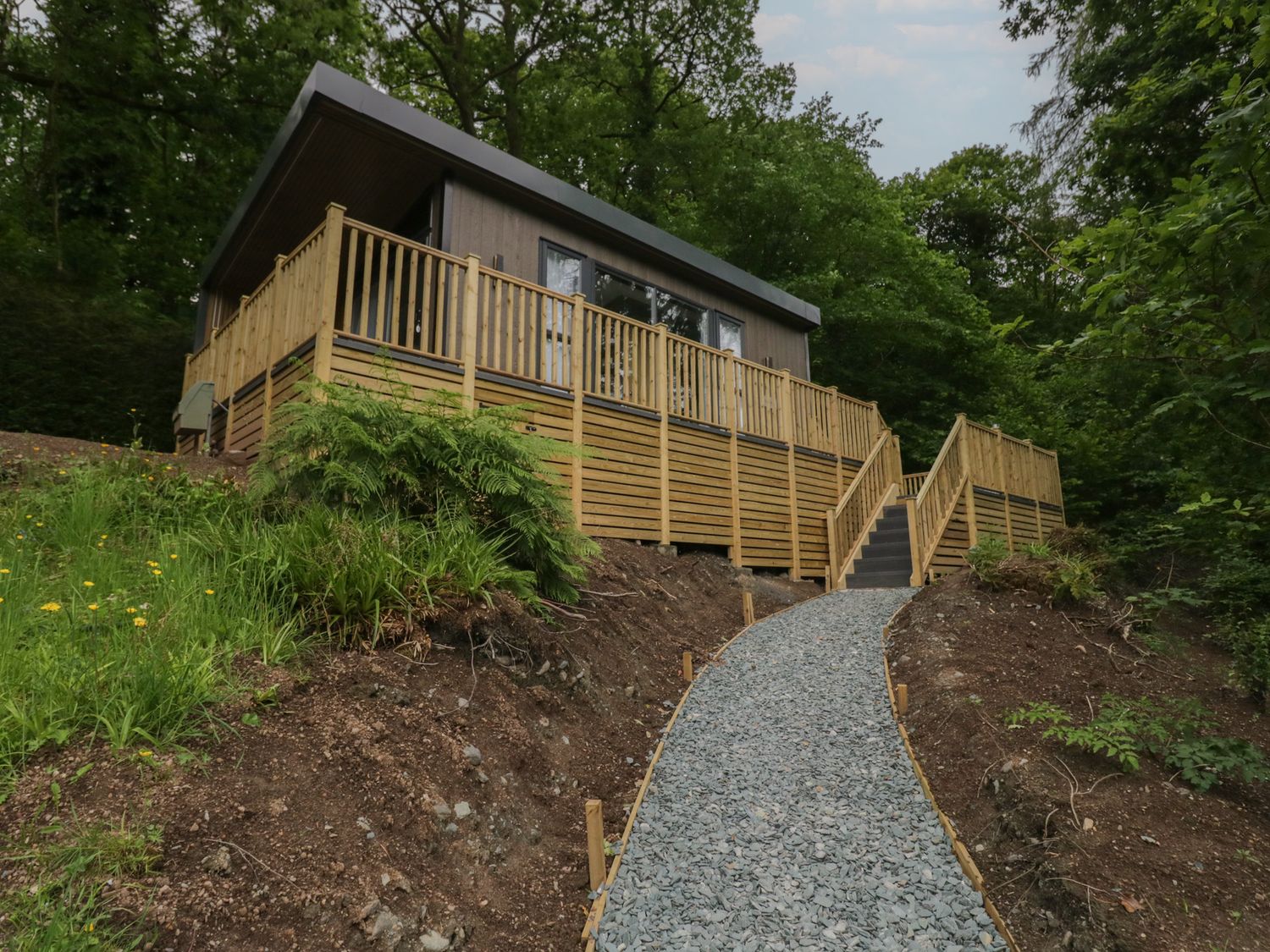 A building with decking and a pathway at Hodge Luxury Pod in Keswick
