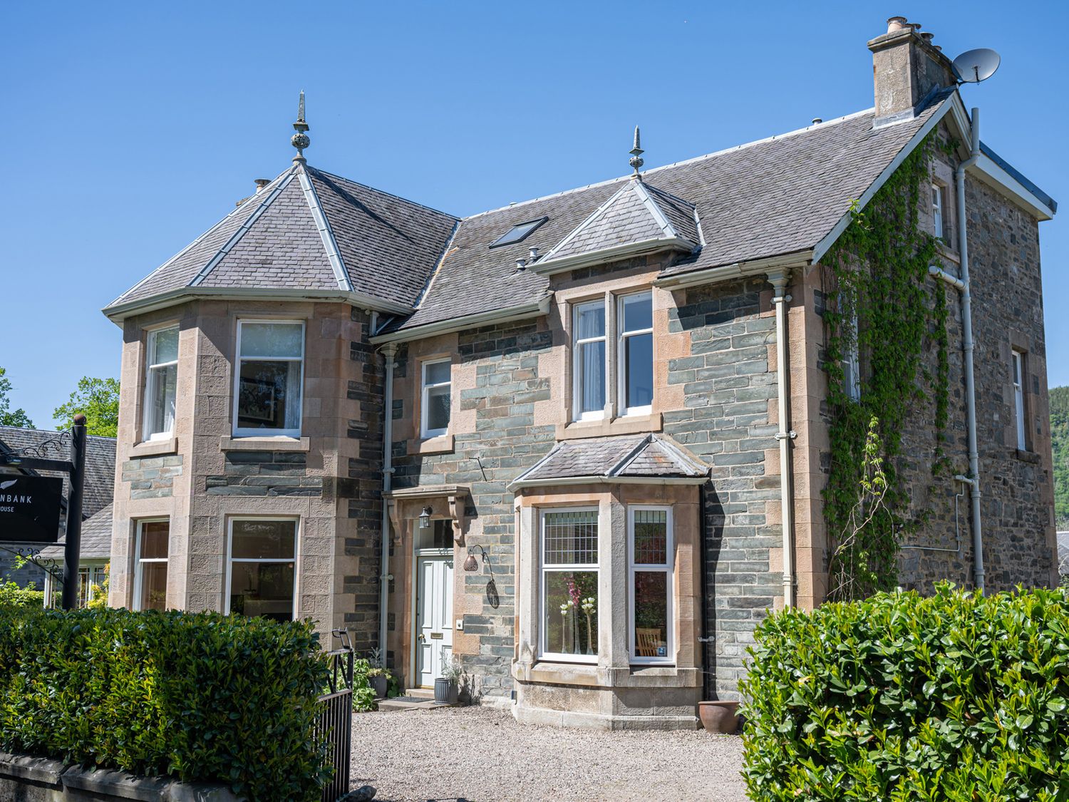 A house with windows and a sign at Fernbank House in Aberfeldy