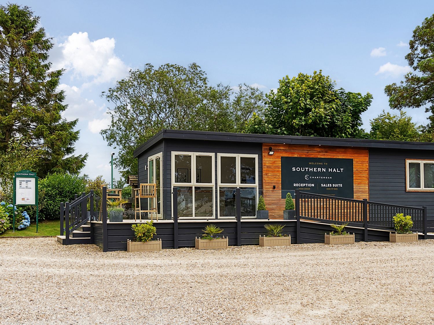 A reception and sales suite building with plants and ramp at Southern Halt in Dobwalls