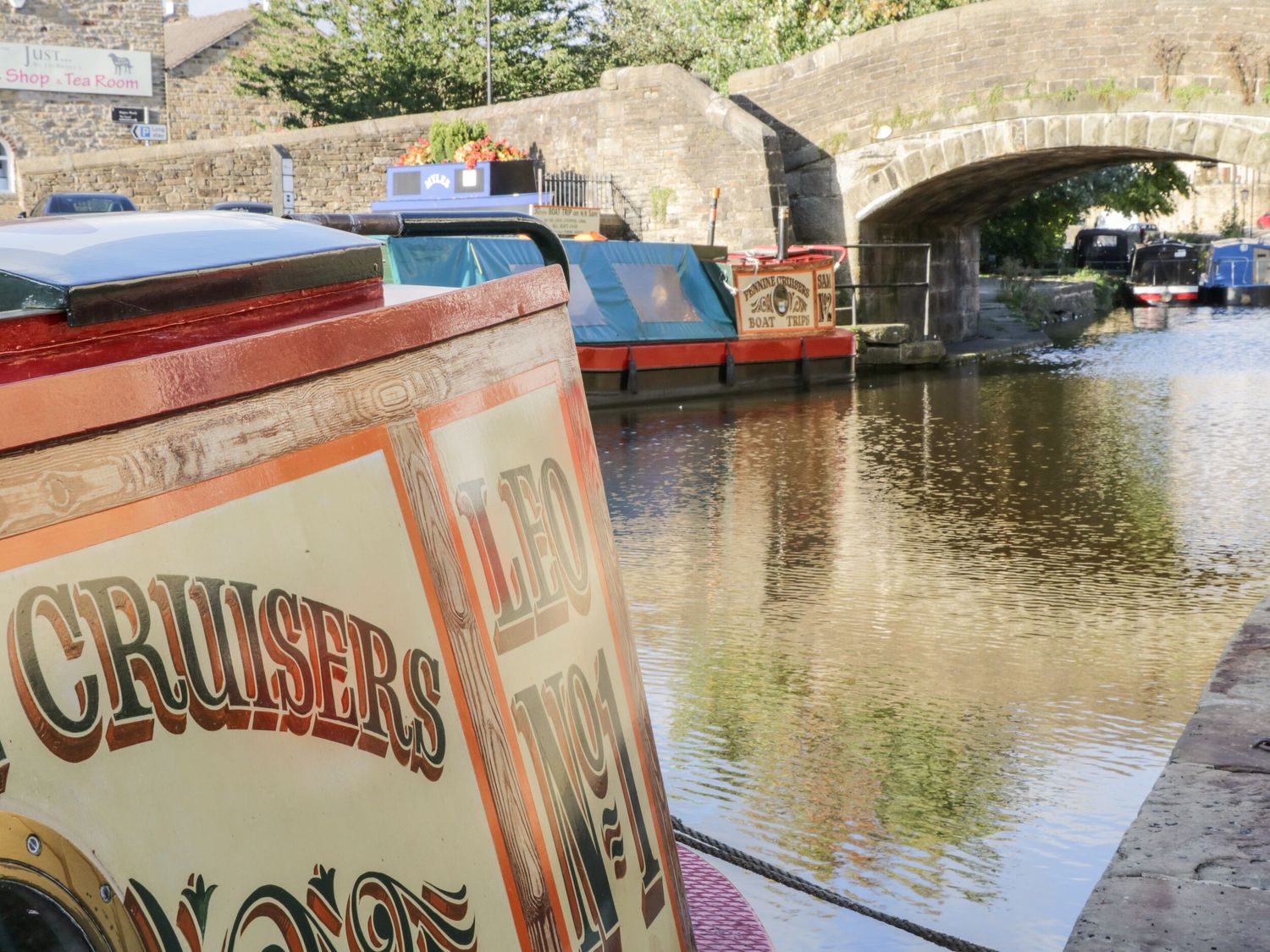 A canal with boats and a bridge at Canal Side in Skipton